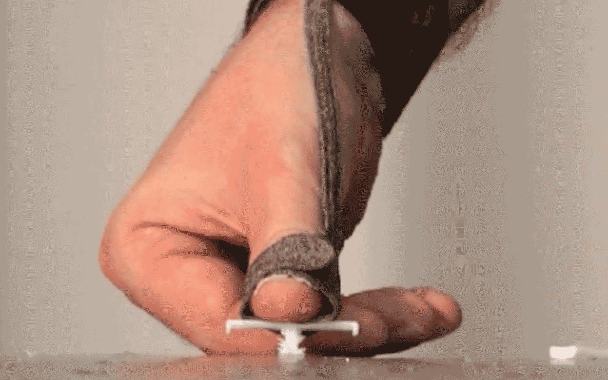 thumb pushing automobile fasterner into place while being measured with buttonsens